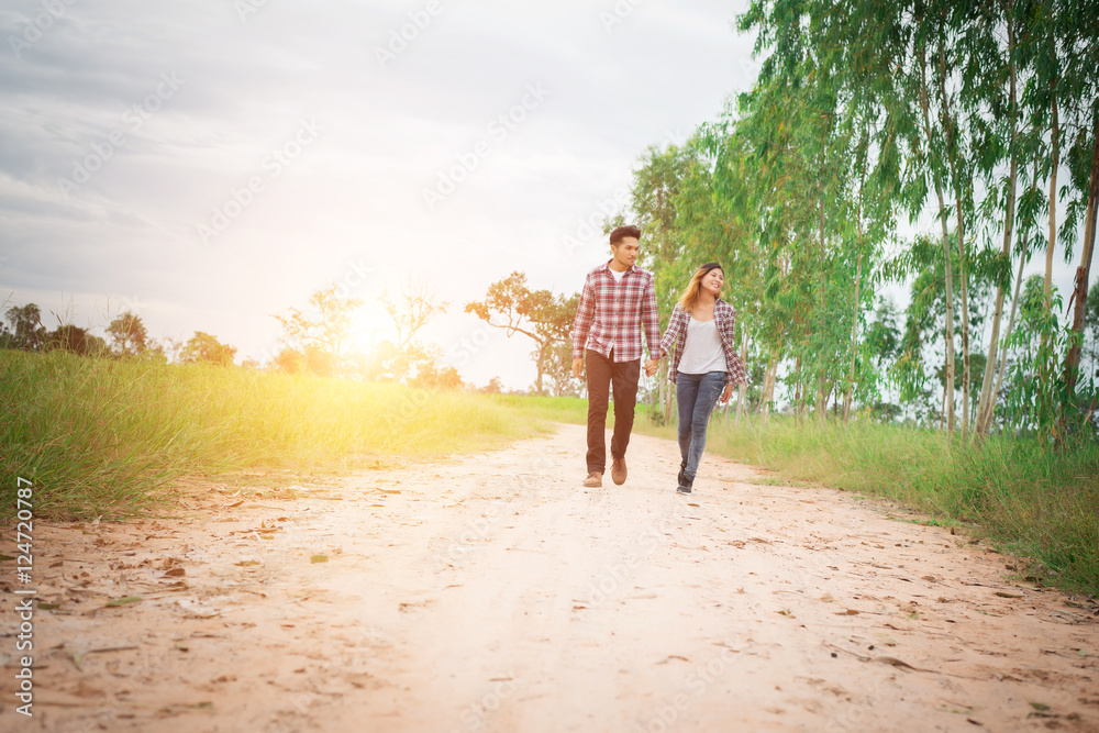 Young hipster couple walking on rural road enjoying with nature, Young hipster couple walking on rural road enjoying with nature,