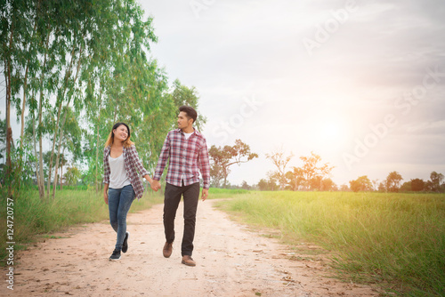 Young hipster couple walking on rural road enjoying with nature,
