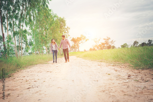Young hipster couple walking on rural road enjoying with nature,