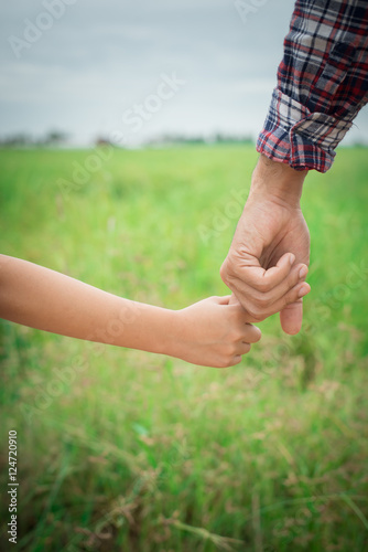 Close up of father holding his daughter hand, so sweet,family ti
