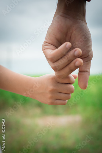 Close up of father holding his daughter hand, so sweet,family ti © Johnstocker