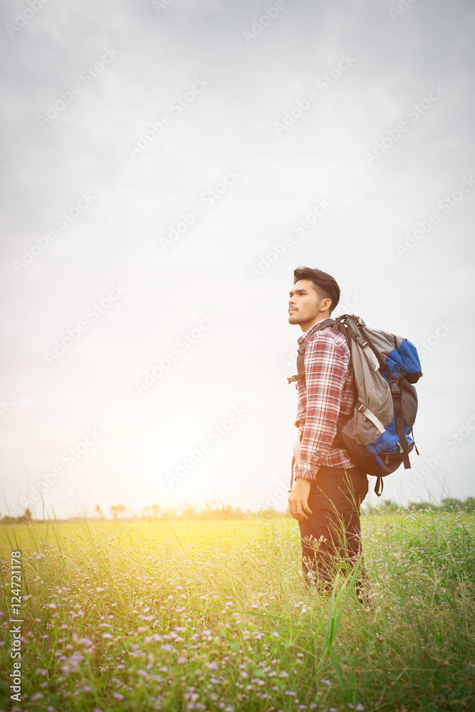 Hipster man with a backpack on his shoulders,time to go travelin Hipster man with a backpack on his shoulders,time to go travelin