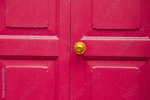 Door knob golden color with pink, door background
