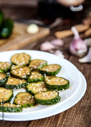 Slices of pickled cucumbers with sesame seeds
