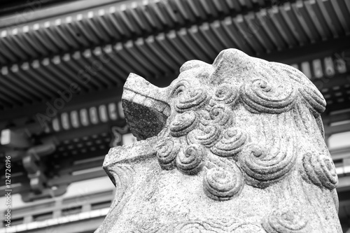  Kyoto, Japan - Statue of lion-dog at the main gate as the guardian of Beautiful Architecture Kiyomizu-dera Temple (black and white).