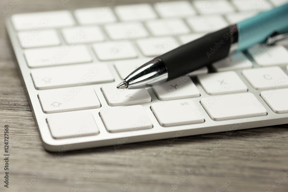 Ein Computer und Kugelschreiber