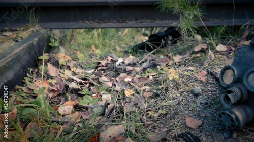 old gas mask on the railroad, horizontal camera movement