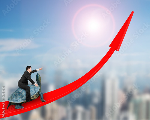 Businessman riding turtle on red arrow up