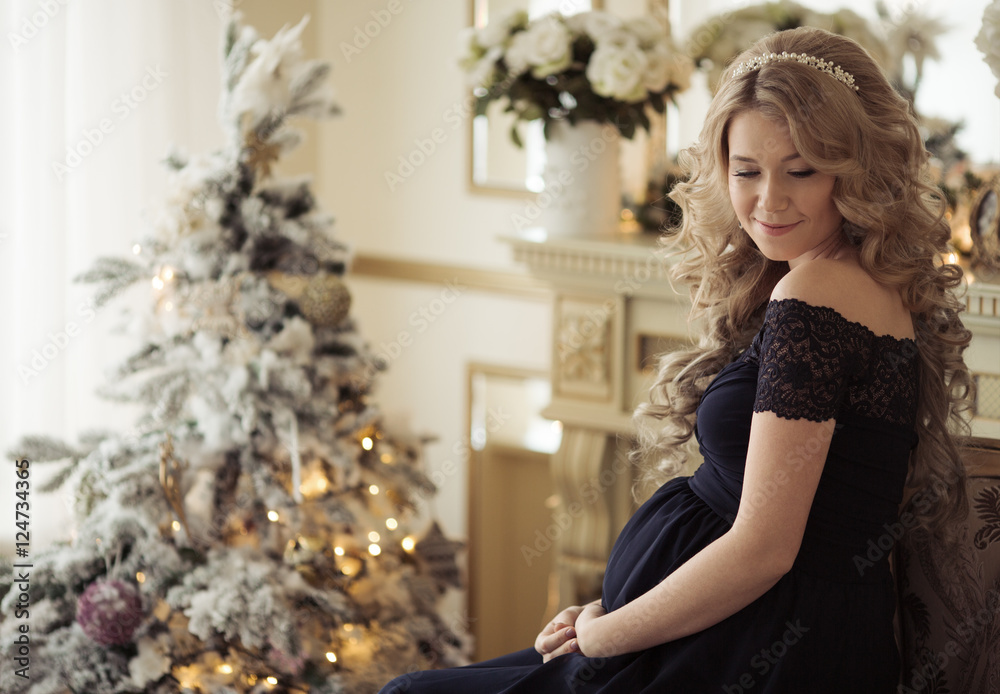 Beautiful Pregnant Woman In A Holiday Dress. Christmas Tree Beautiful Pregnant Woman In A Holiday Dress. Christmas Tree