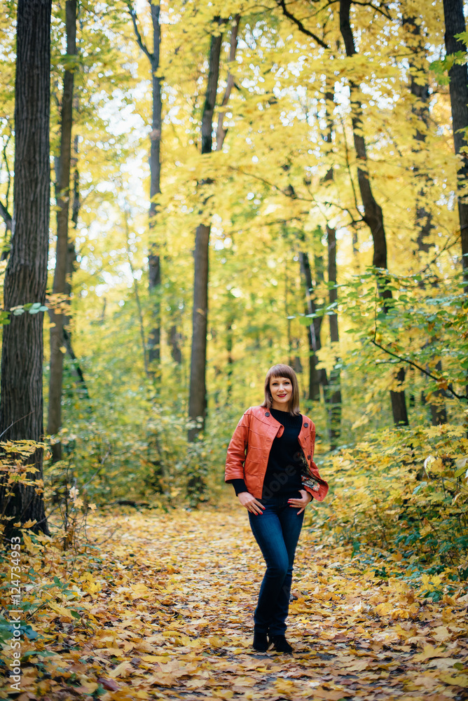 girl walking in the autumn yellow wood, maple grove girl walking in the autumn yellow wood, maple grove