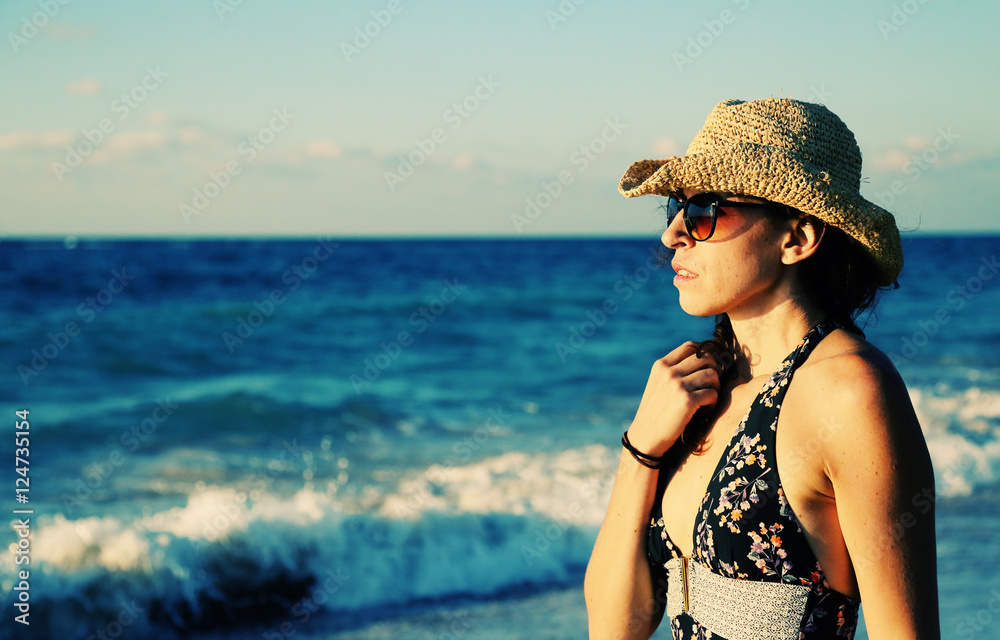 Beautifull 40 years old woman walking on the beach