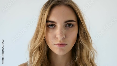 model in short denim shorts goes barefoot on the white floor