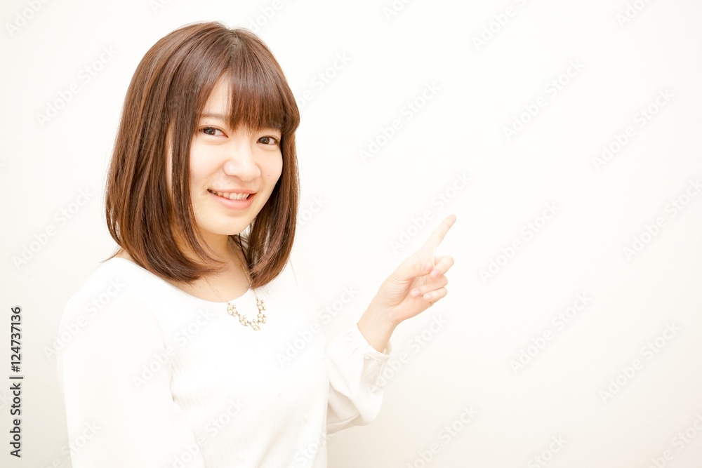 Young Japanese woman pointing something with smile Young Japanese woman pointing something with smile