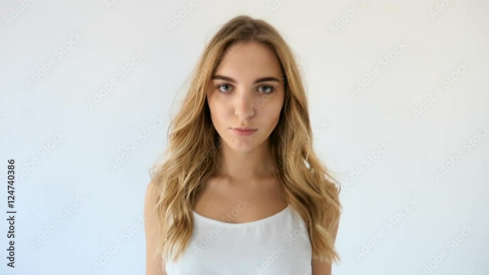 model in short denim shorts goes barefoot on the white floor model in short denim shorts goes barefoot on the white floor