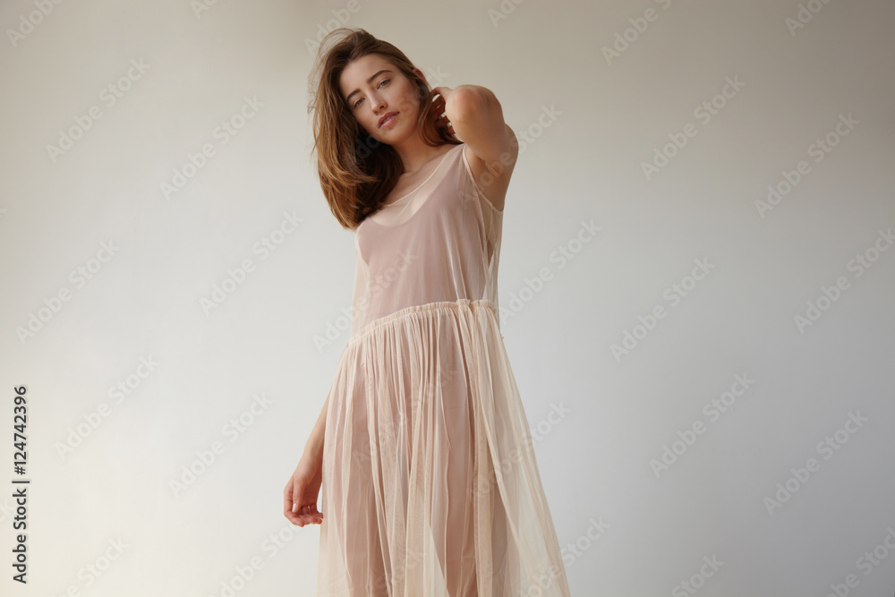 woman touches her hair and watching at camera. daylight style woman touches her hair and watching at camera. daylight style