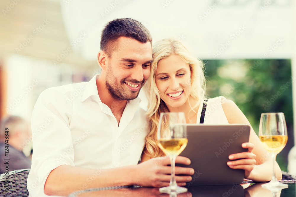 happy couple with tablet pc at restaurant lounge happy couple with tablet pc at restaurant lounge