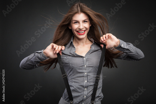 Happy woman pulling suspenders.