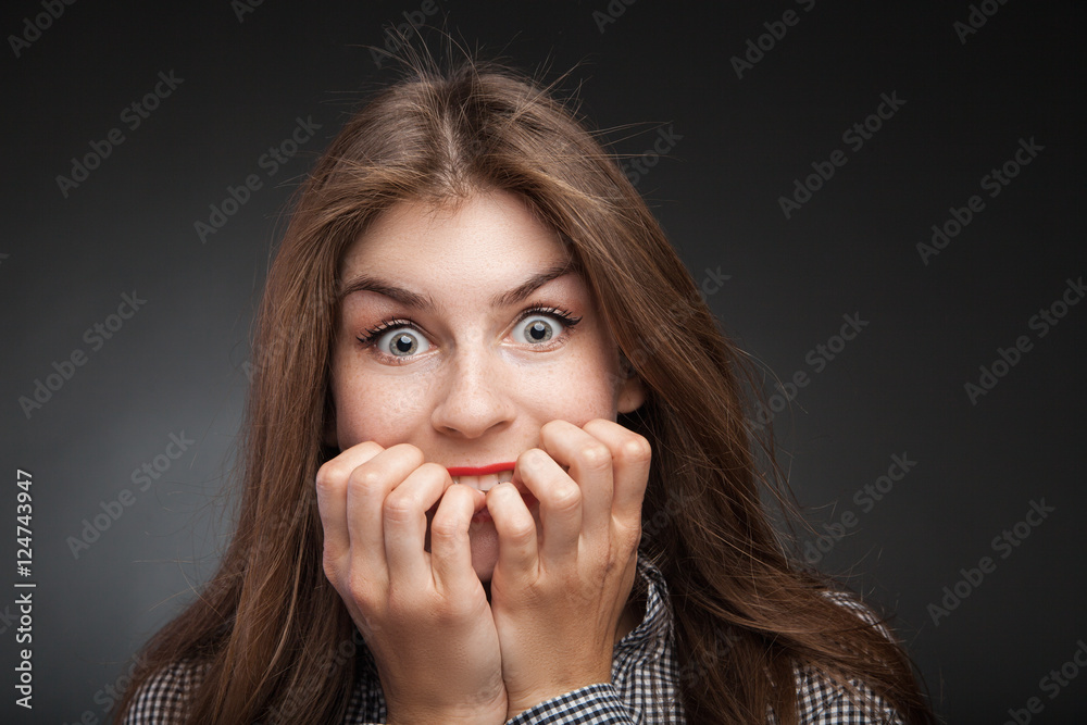 Amazed woman biting nails. Amazed woman biting nails.