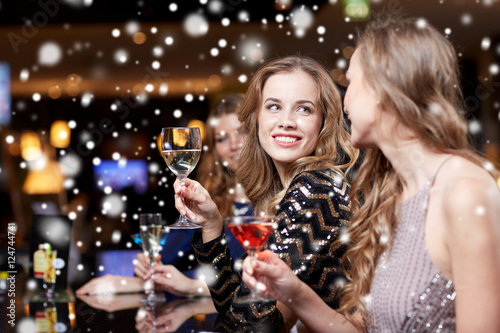 happy women with drinks at night club