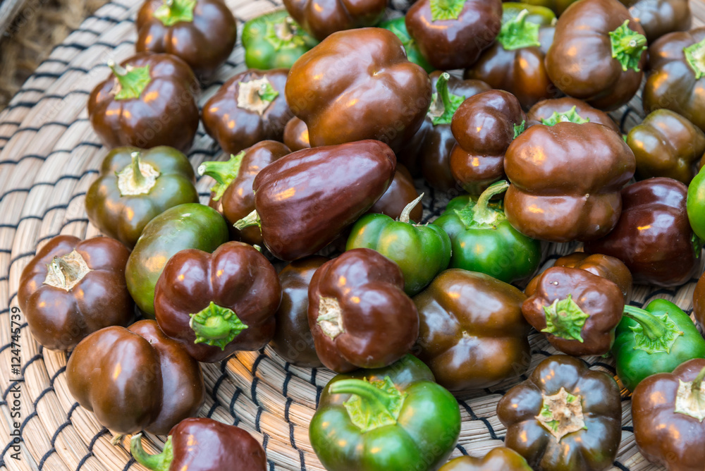 Obraz premium small green and black peppers in a basket