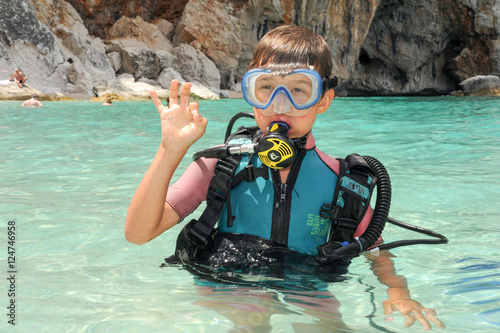Child discover scuba diving at Cala Mariolu beach on Sardinia