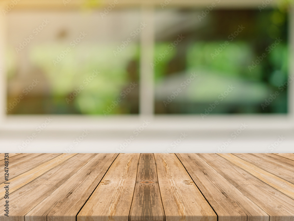 Wooden board empty table top on of blurred background. Perspective brown wood table over blur in coffee shop background - can be used mock up for montage products display or design key visual layout. Wooden board empty table top on of blurred background. Perspective brown wood table over blur in coffee shop background - can be used mock up for montage products display or design key visual layout.