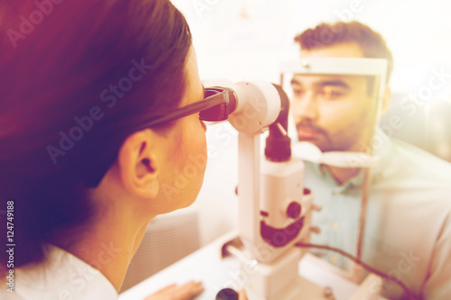 optician with slit lamp and patient at eye clinic