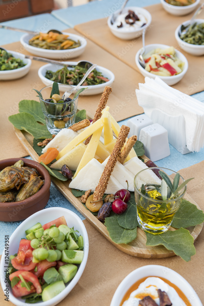 Cheese plate with variety of appetizers on table Cheese plate with variety of appetizers on table
