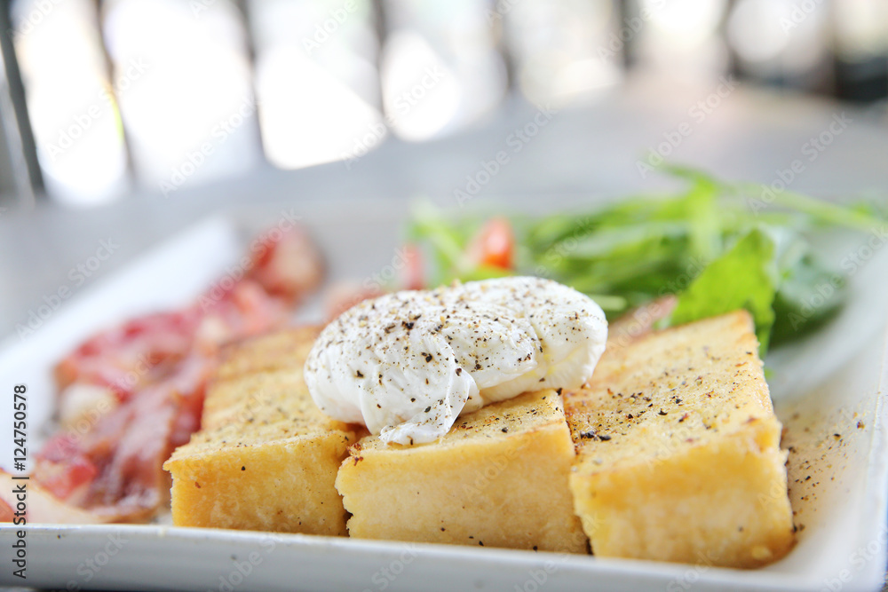 egg benedict with bacon on wood background , breakfast