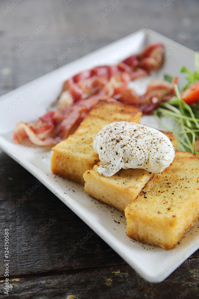 egg benedict with bacon on wood background , breakfast