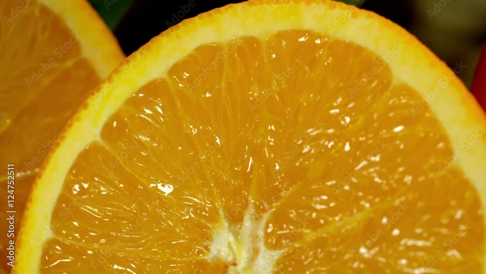 Group of oranges with leaves on wooden boards. Orange cut in half