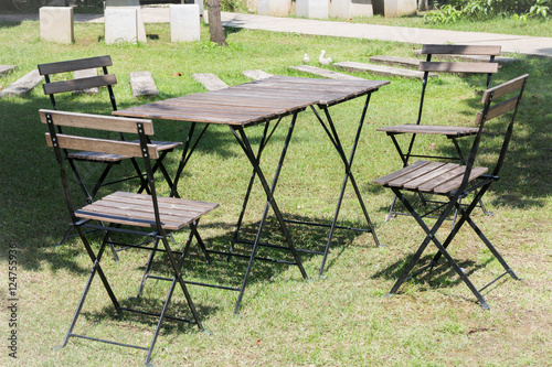 Outdoor tables and chairs set up on the green lawn