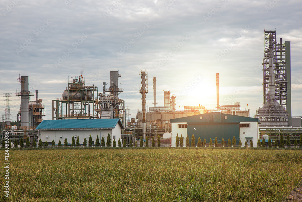 Oil and gas refinery industry plant, sunset and Chemical storage tanks