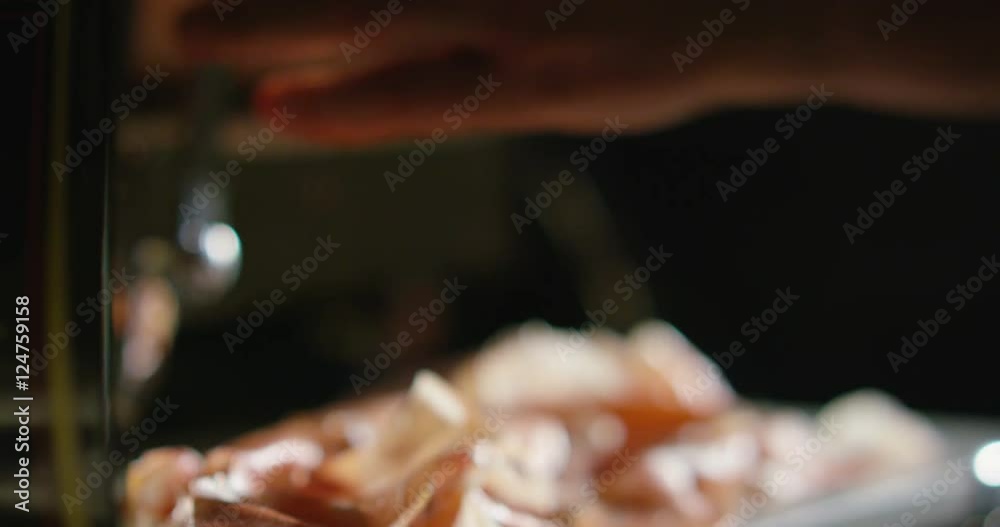 affattatura of a slice of Italian ham with a professional slicer and gives off taste and high quality flavors affattatura of a slice of Italian ham with a professional slicer and gives off taste and high quality flavors