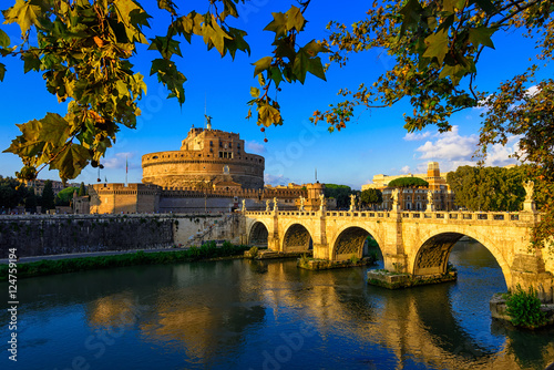 Castle Sant Angelo (Mausoleum of Hadrian), bridge Sant Angelo and river Tiber in the rays of sunset in Roma. Italy