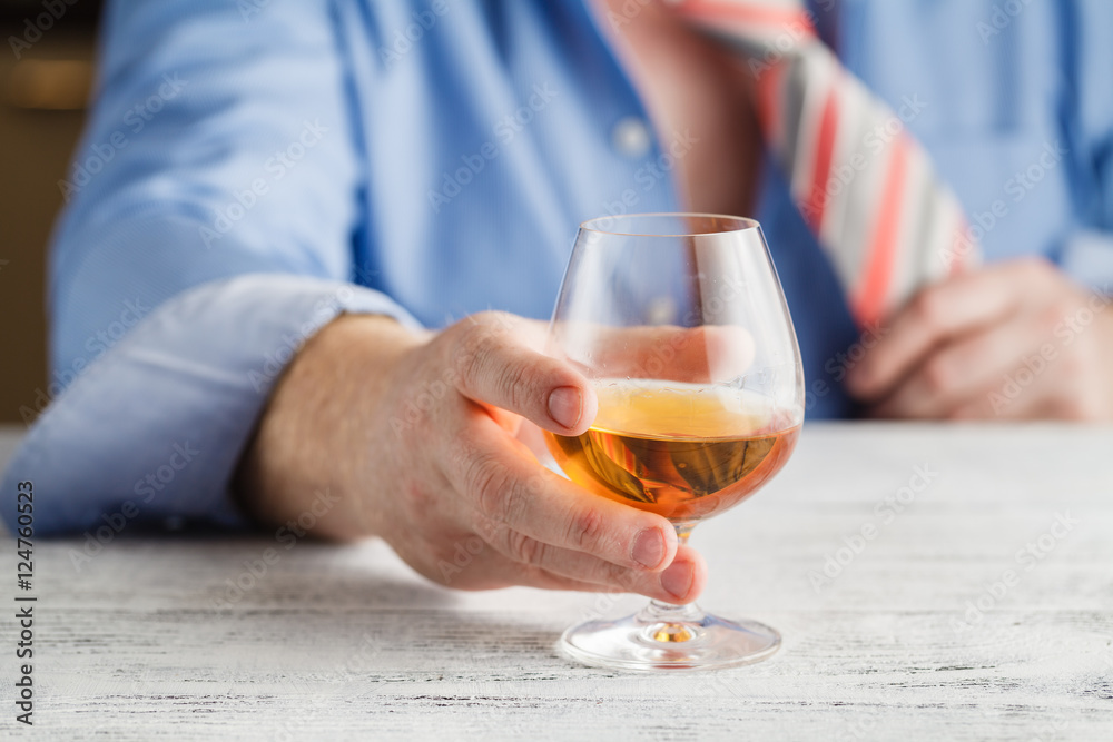 Young alcoholic man drinking whisky in his home. Young alcoholic man drinking whisky in his home.