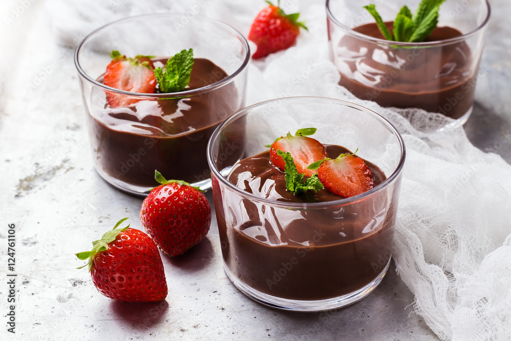 Chocolate mousse with strawberries in glass on rustic table Chocolate mousse with strawberries in glass on rustic table