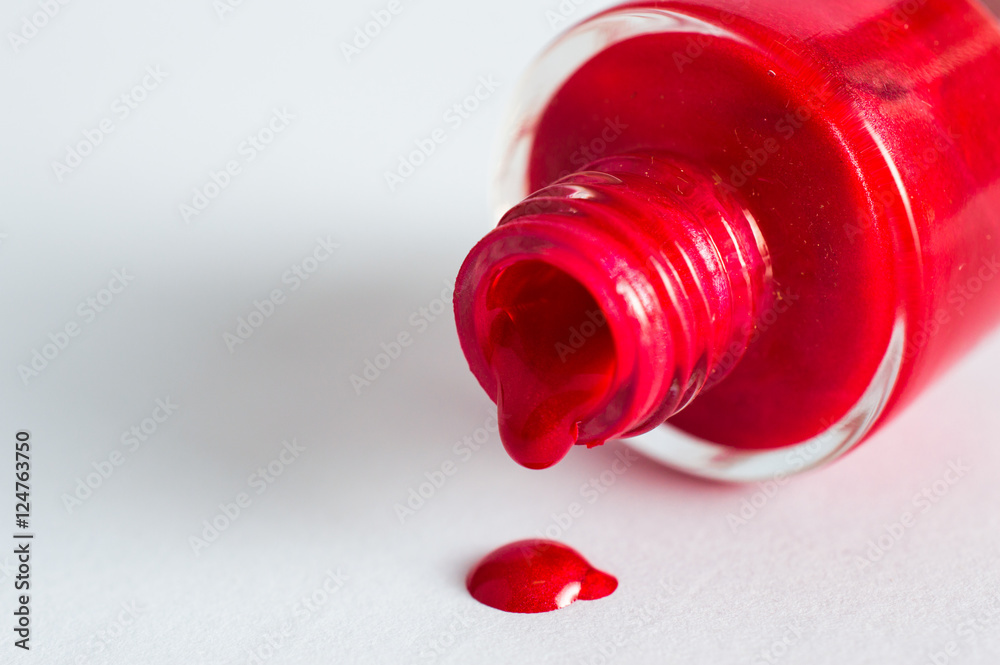 Open red nail polish. On white, isolated background. Macro. Close up