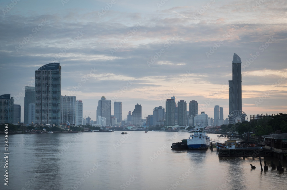 View of the Chao-Phraya-River at dawn with gray cloud cover. Bangkok, Thailand.