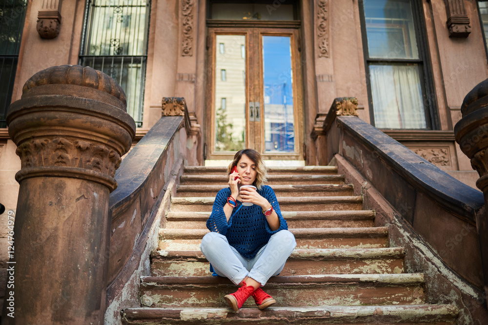 Woman with phone in the New York city posing