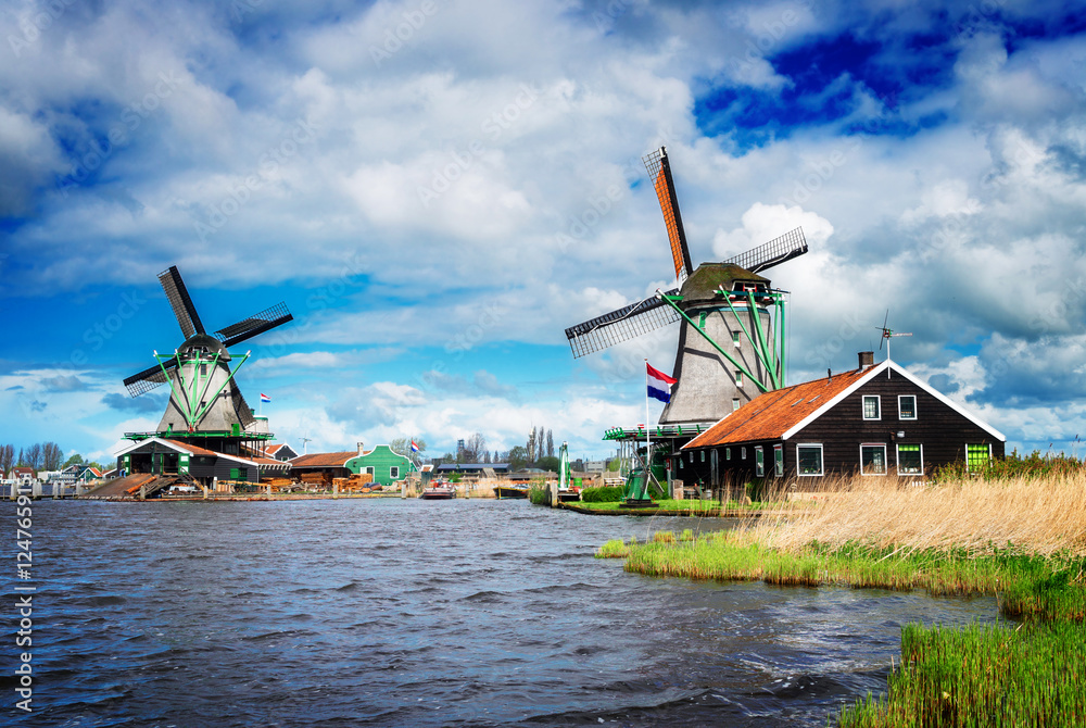 two traditional Dutch windmills of Zaanse Schans, Netherlands, retro toned