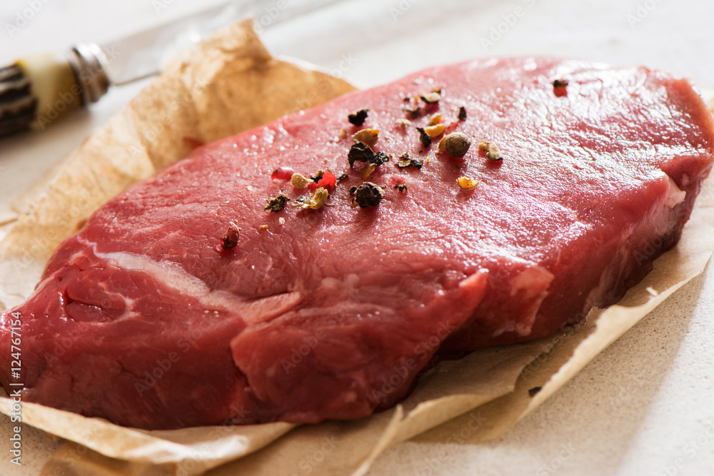 Raw beef tenderloin with peppercorns