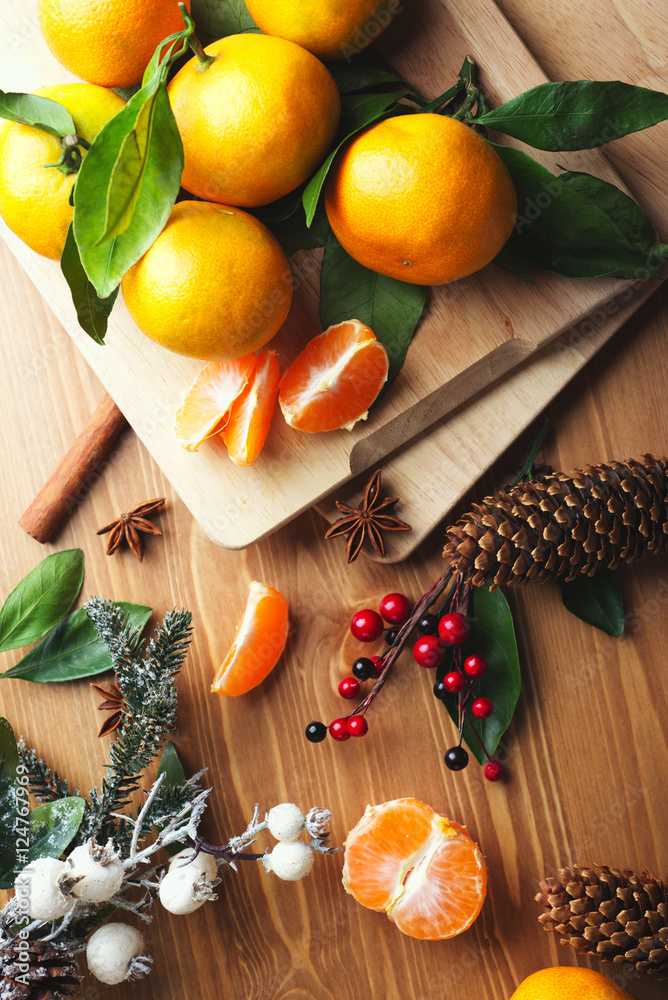 Top view of tangerines with leaves in Christmas decor. Top view of tangerines with leaves in Christmas decor.