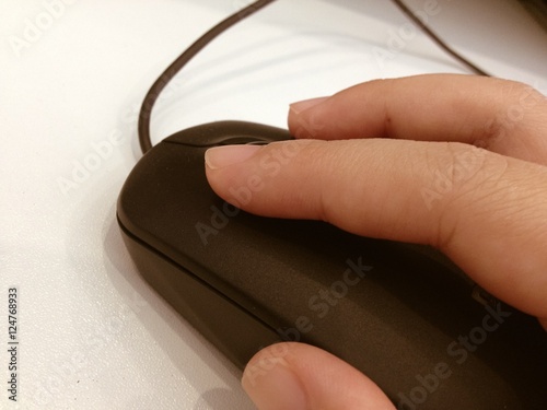 close up of hand with computer mouse on blurred background