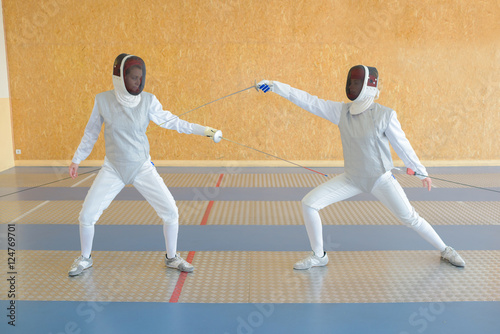 Two people in fencing joust