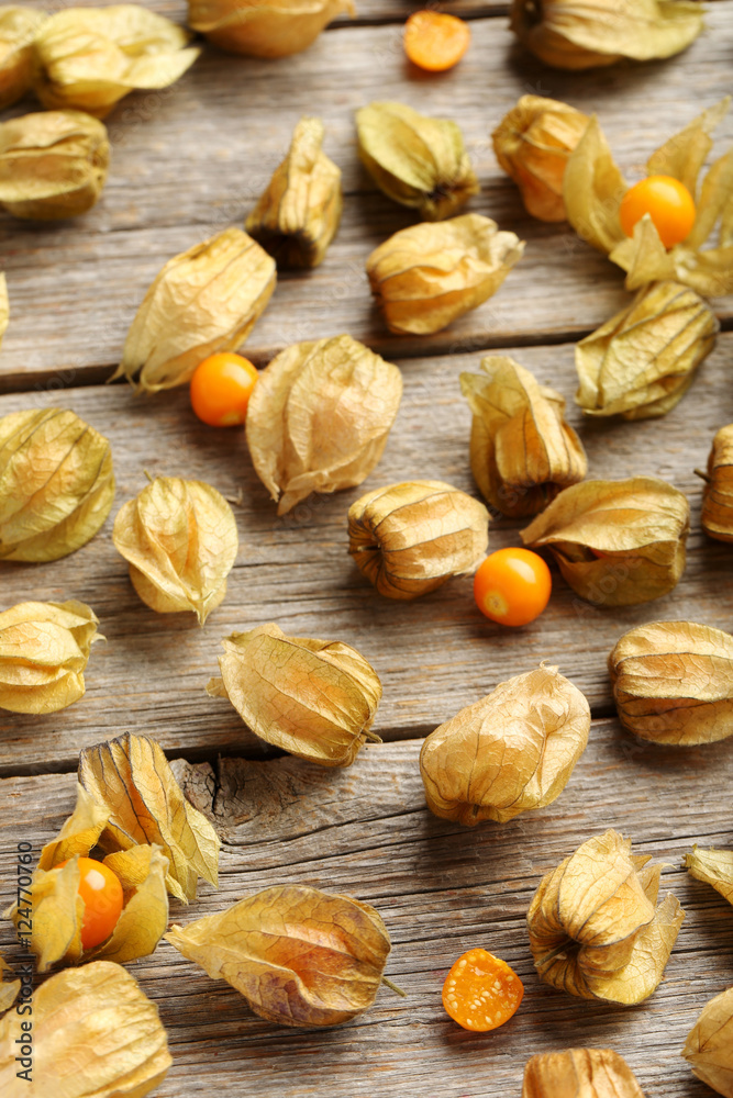 Fototapeta premium Ripe physalis on a grey wooden table