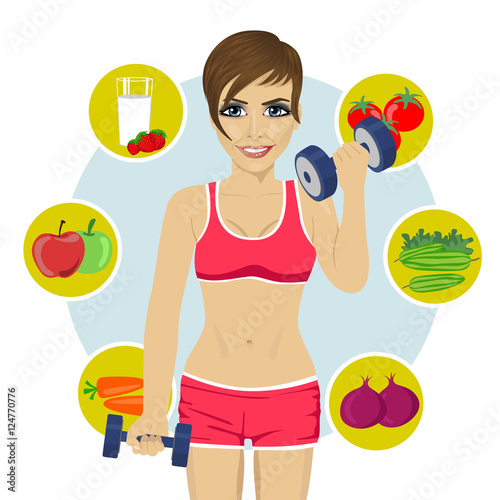 sporty woman with dumbbells and variety of healthy fruits