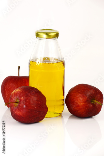 Fresh apples and a bottle of apple cider vinegar.