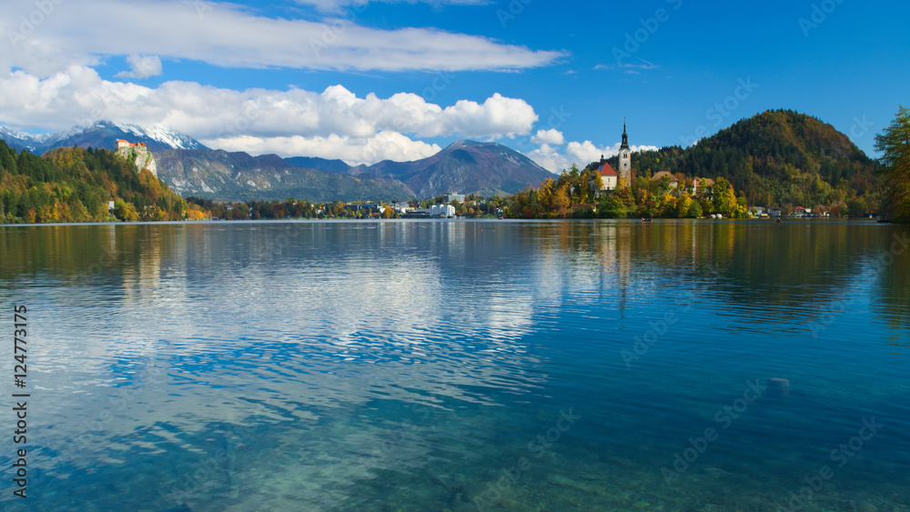 View of the castle and of the Church of the Assumption in the island of the Lake of Bled (Blejsko jezero) with the Karawanks Alps in the background, Slovenia
