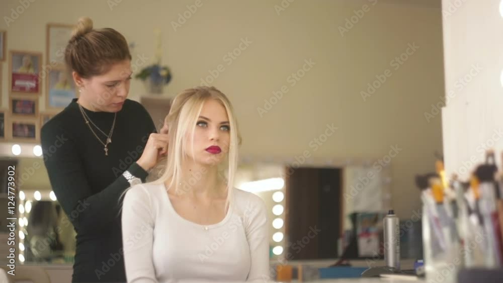 Hairdresser makes hairstyle blonde girl. Hairdresser makes hairstyle blonde girl.